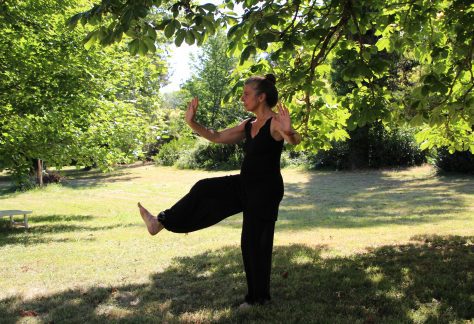 Woman practices Tai Chi outside the Betty Ford Alpine Gardens
