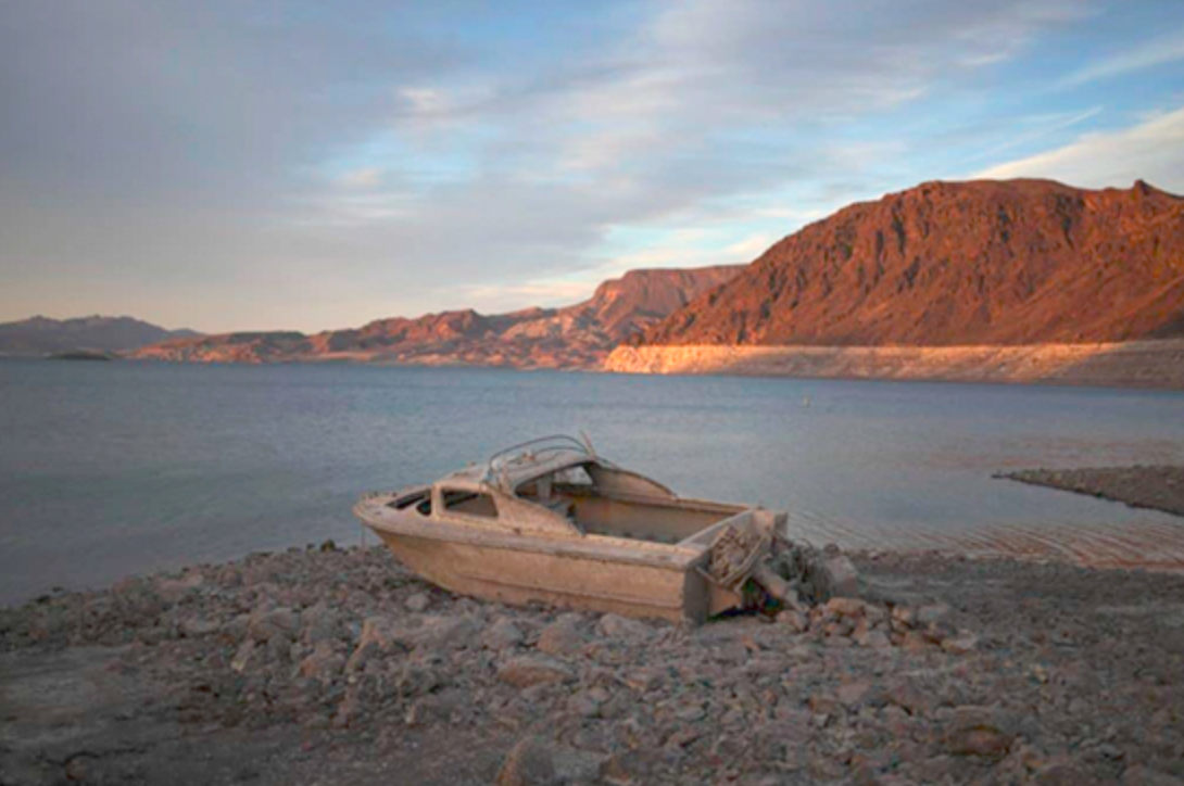 A formerly sunken boat sits high and dry along the shoreline of Lake Mead at the Lake Mead National Recreation Area